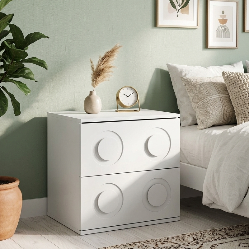 Modern bedroom with a white nightstand, bed with pillows, and wall art.