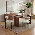 Dining room with wooden table, chairs, and decorative elements.