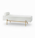 White upholstered bench with gold legs on a white background