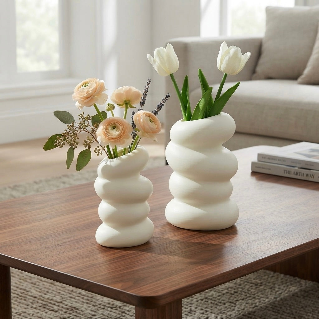 Two spiral white nordic vases on walnut coffee table with tulips and ranunculus