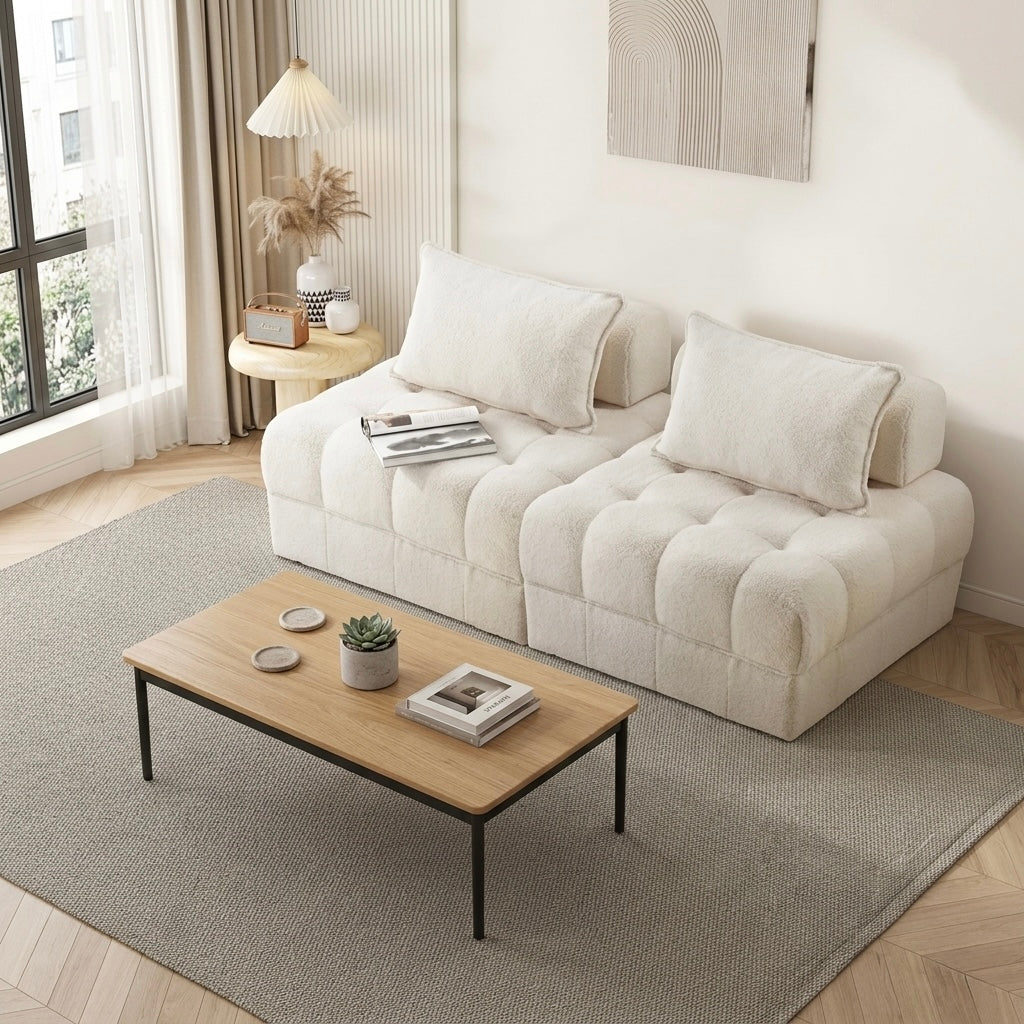 Modern living room with a white sofa, wooden coffee table, and decorative items.