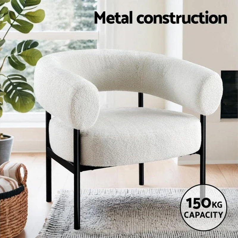 White curved boucle armchair styled in modern bedroom Australian home

